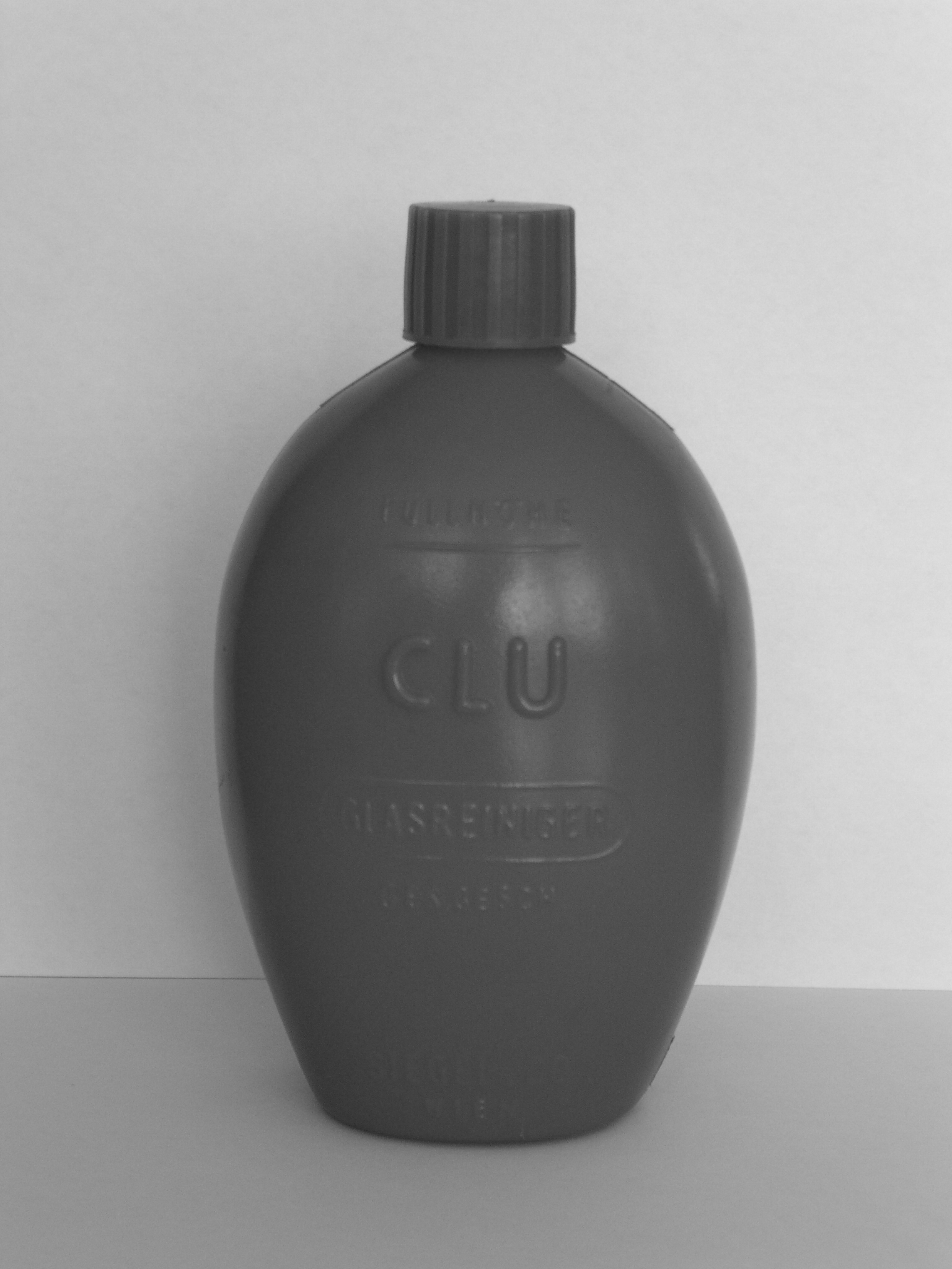 Plastic bottle with ribbed cap on a plain background.