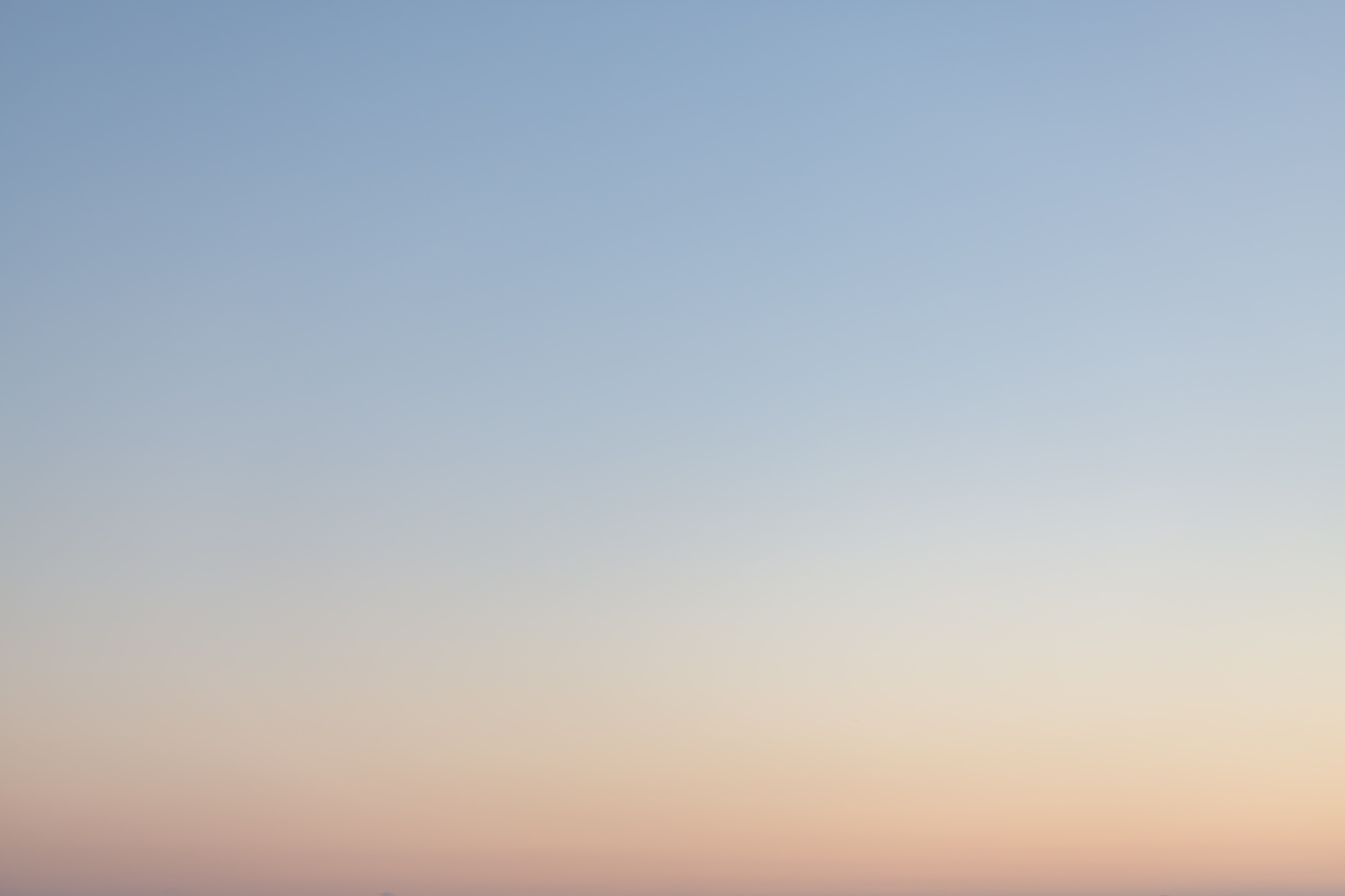 Clear sky with a gradient from light blue to peach at sunset.