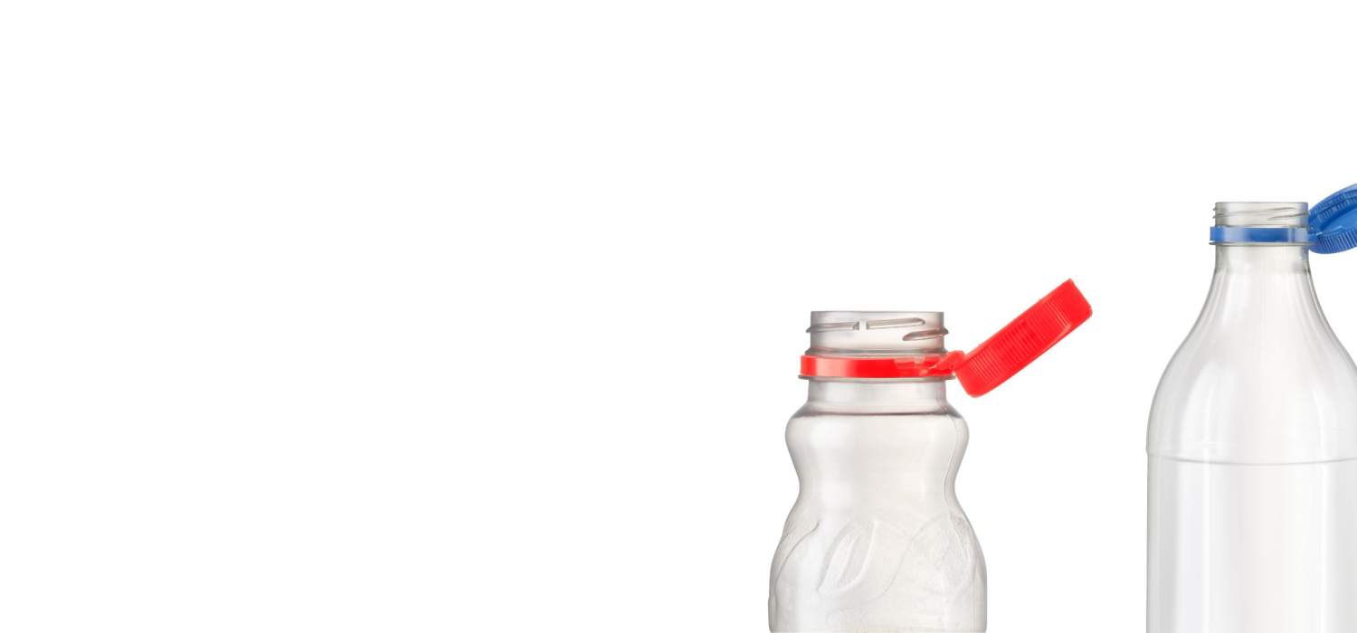 Plastic bottles with red and blue tied caps on white background.