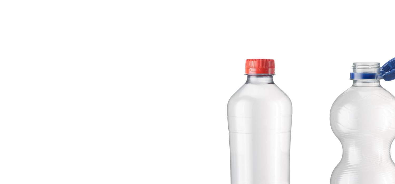 Plastic bottles with red and blue caps on a white background.