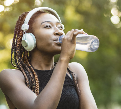 Woman drinking from a reusable PET bottle