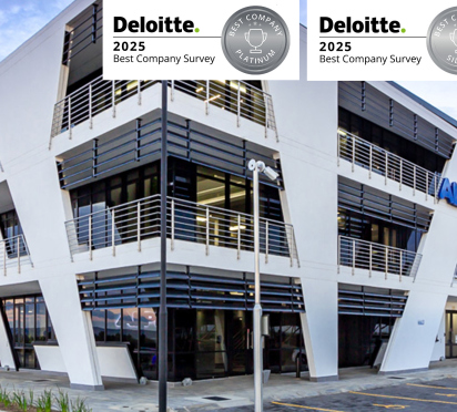 Modern ALPLA building with large windows and an angled roof, under a cloudy sky.