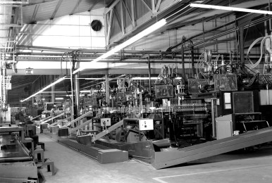 Production line in a factory with machinery and conveyor belts.