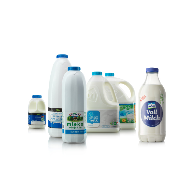 Milk bottles and jugs of various sizes, white with blue caps, arranged against a white background manufactured by ALPLA serving leaders in the Diary industry.